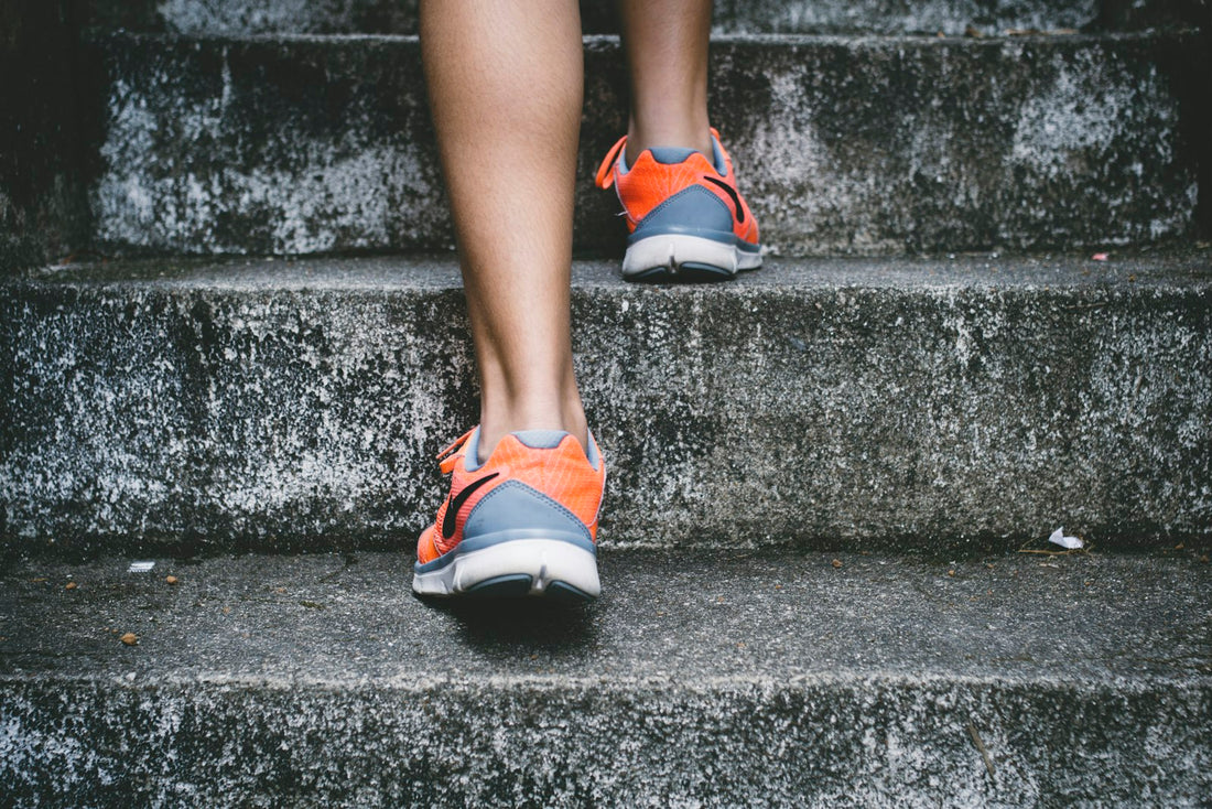 Athletic shoes climbing concrete stairs