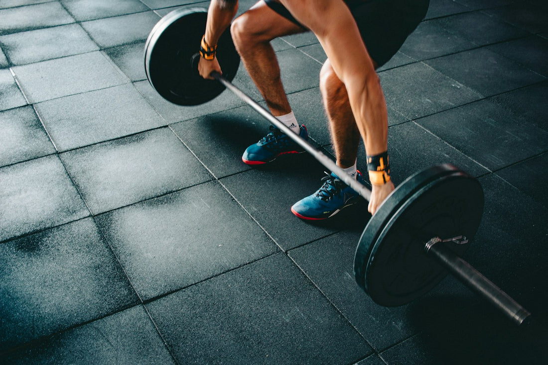 Hands gripping a barbell