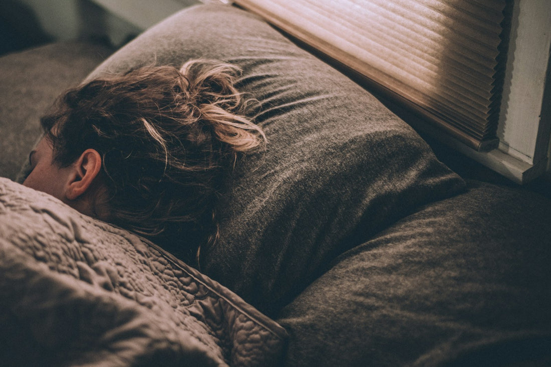 Person sleeping peacefully under blankets