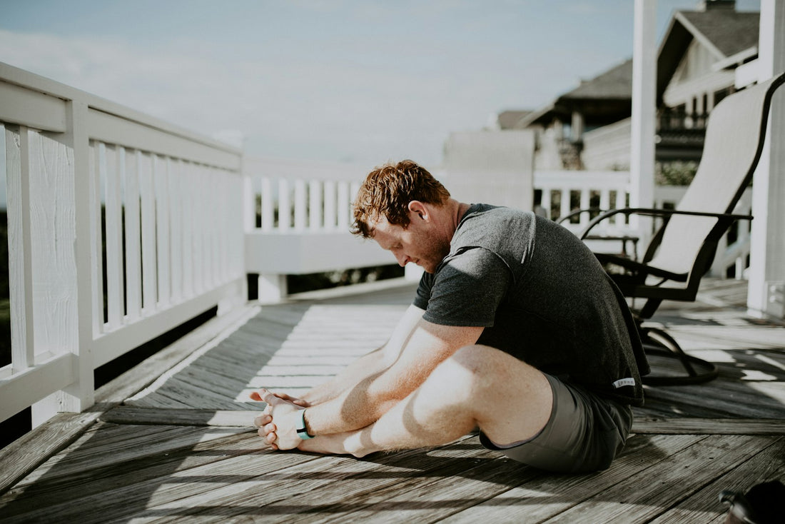 Person resting and stretching on a deck