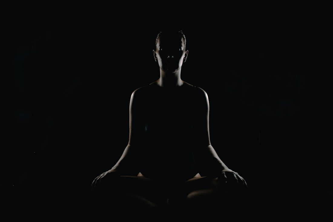 Person sitting in a meditation pose