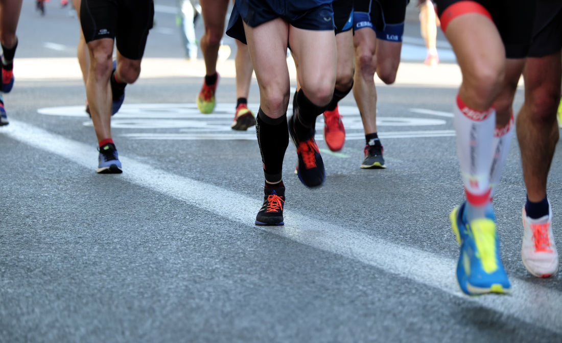 Runners' legs on a road