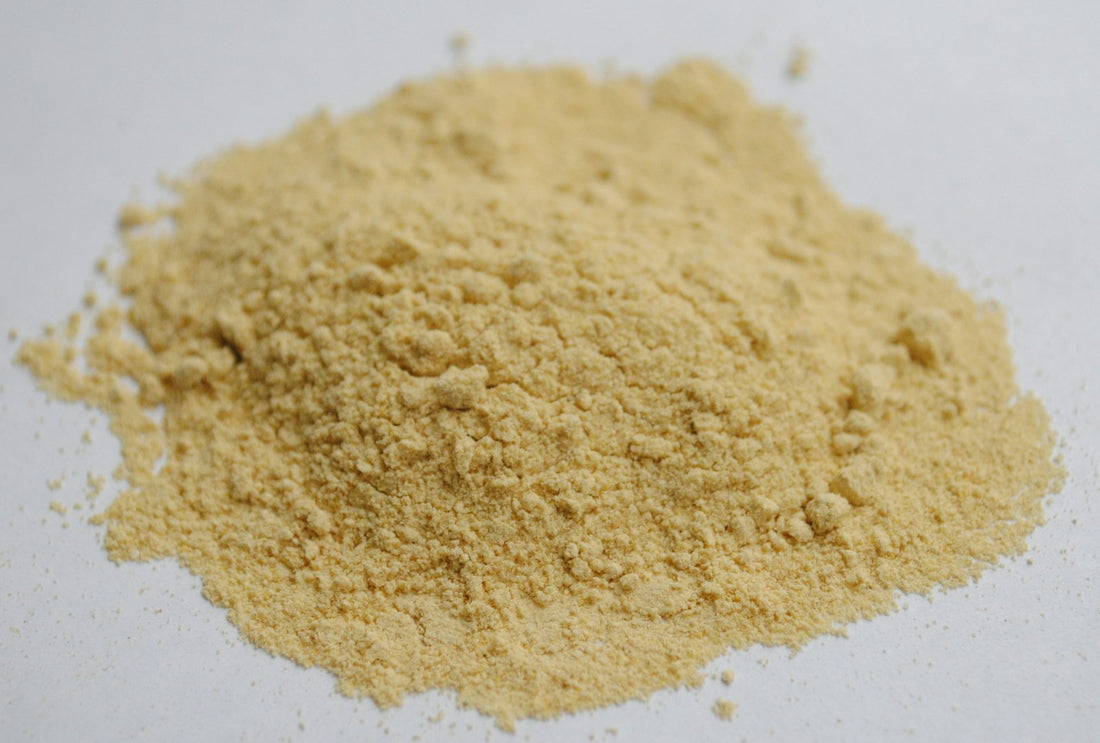 A mound of pale herbal powder on a light surface
