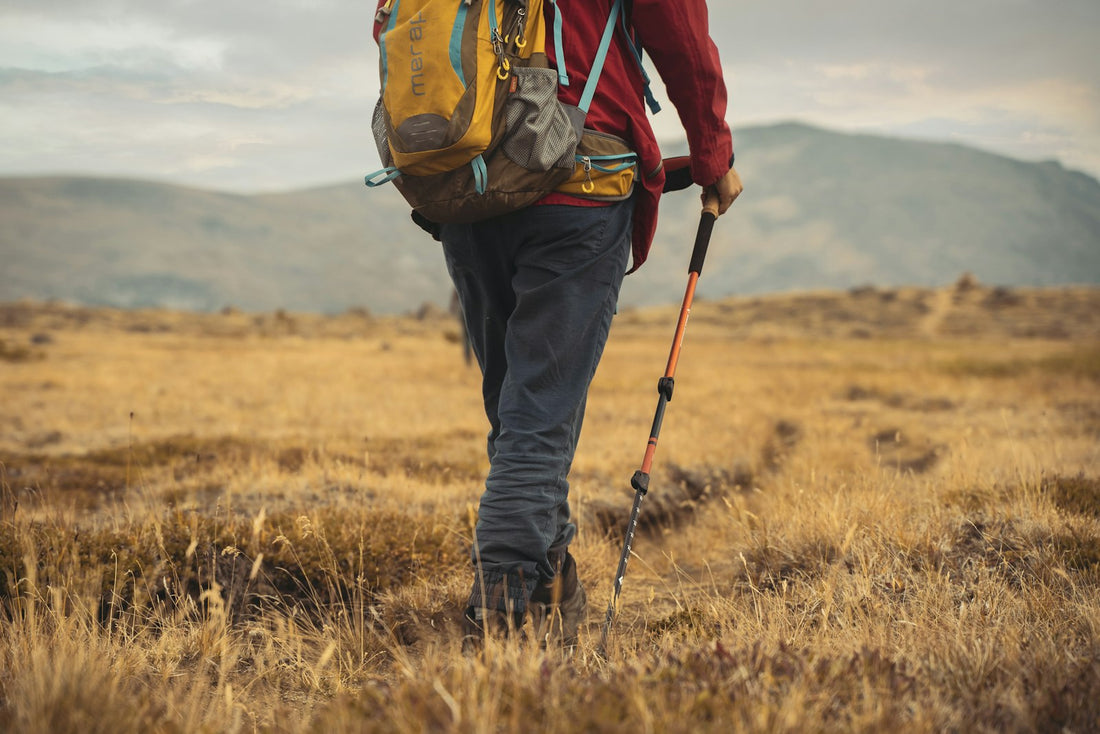 Man walking a trail with a loaded backpack
