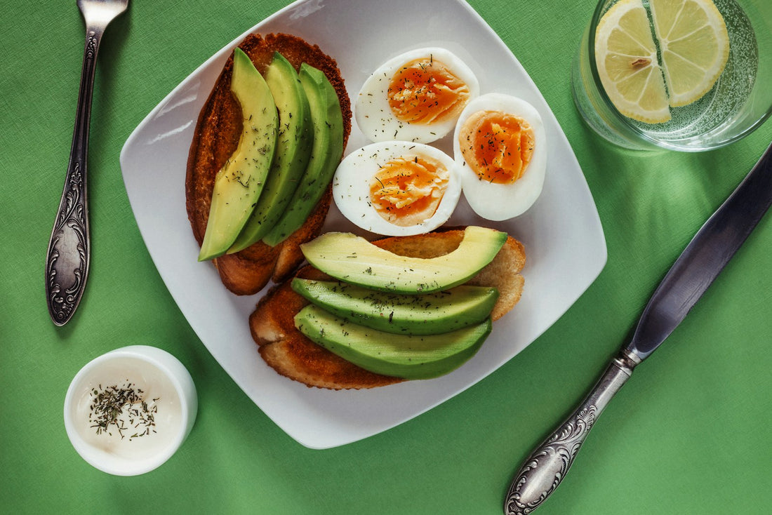 Eggs and avocado on a white plate