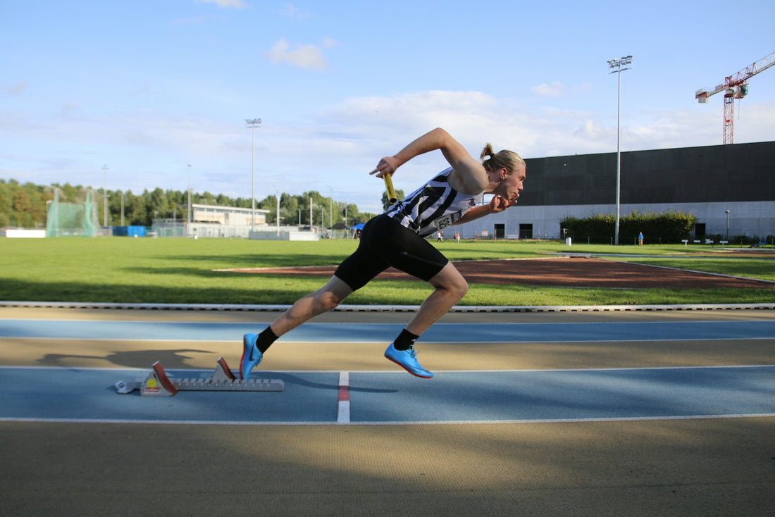 Sprinter accelerating on an athletics track