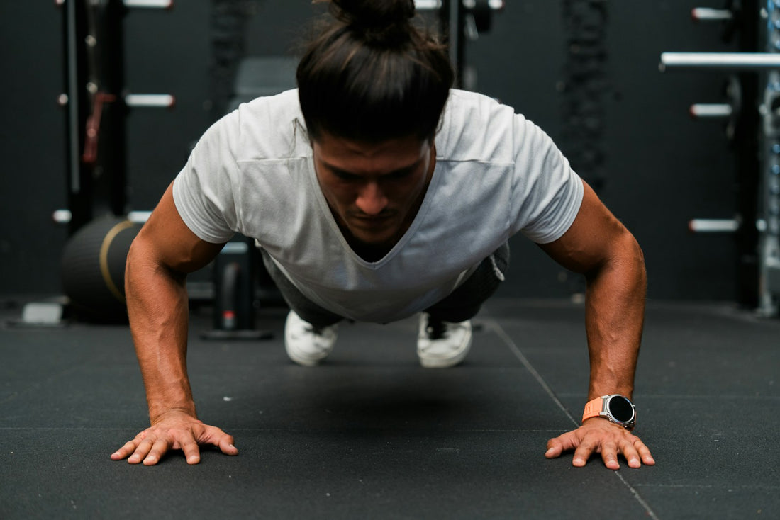 Man performing a push-up in a gym