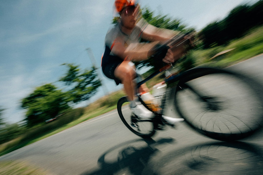 Cyclist riding fast on an open road