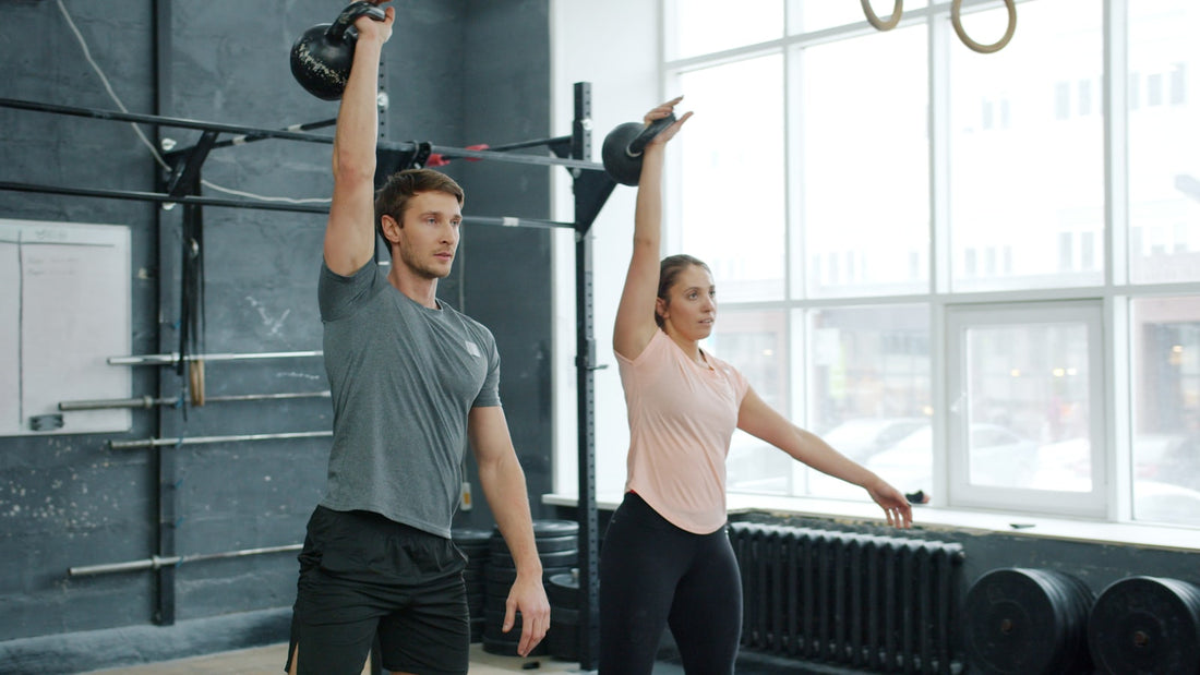 People performing kettlebell swings in a gym