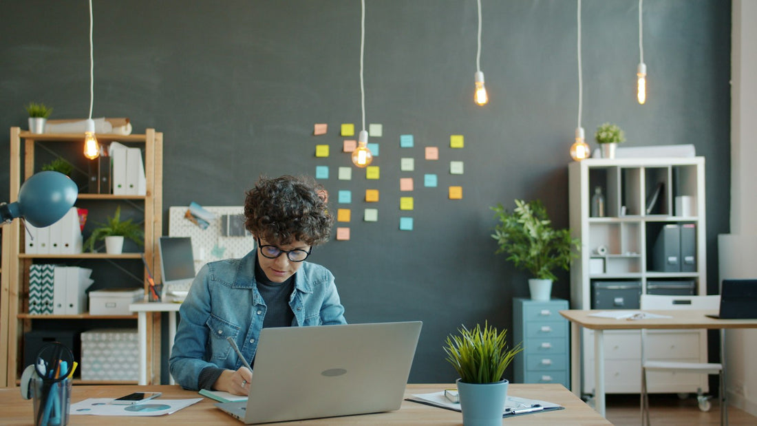 Person working at a laptop in a bright modern office