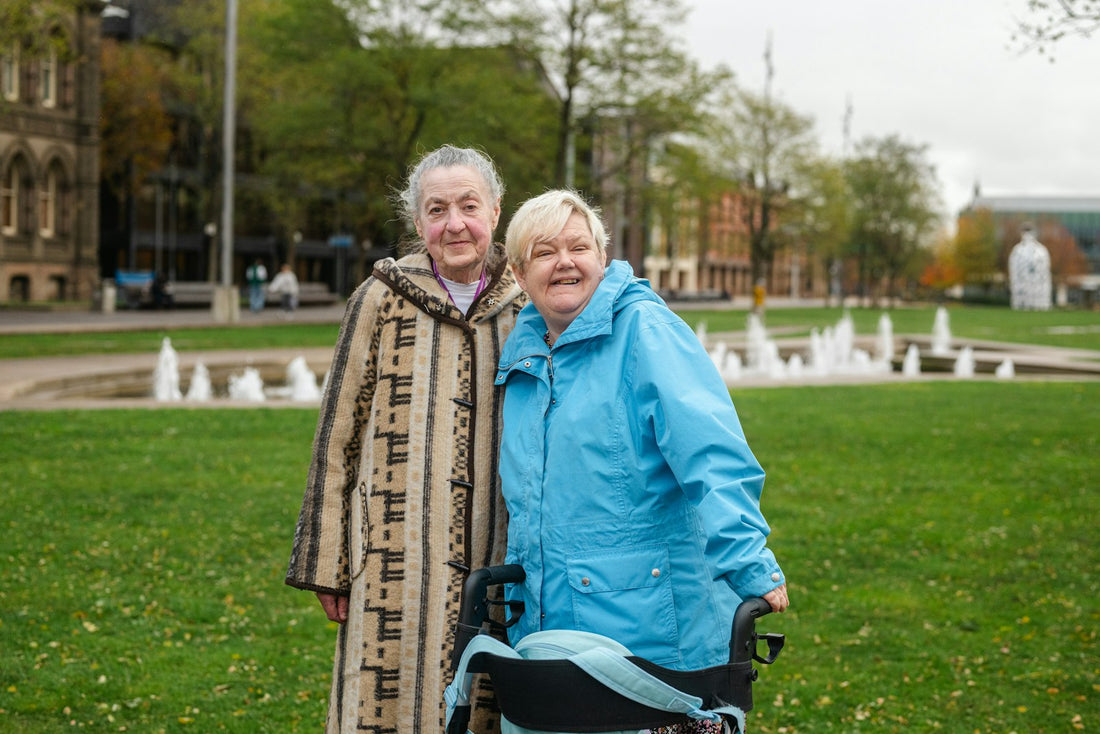 Two older women walking outdoors in a park