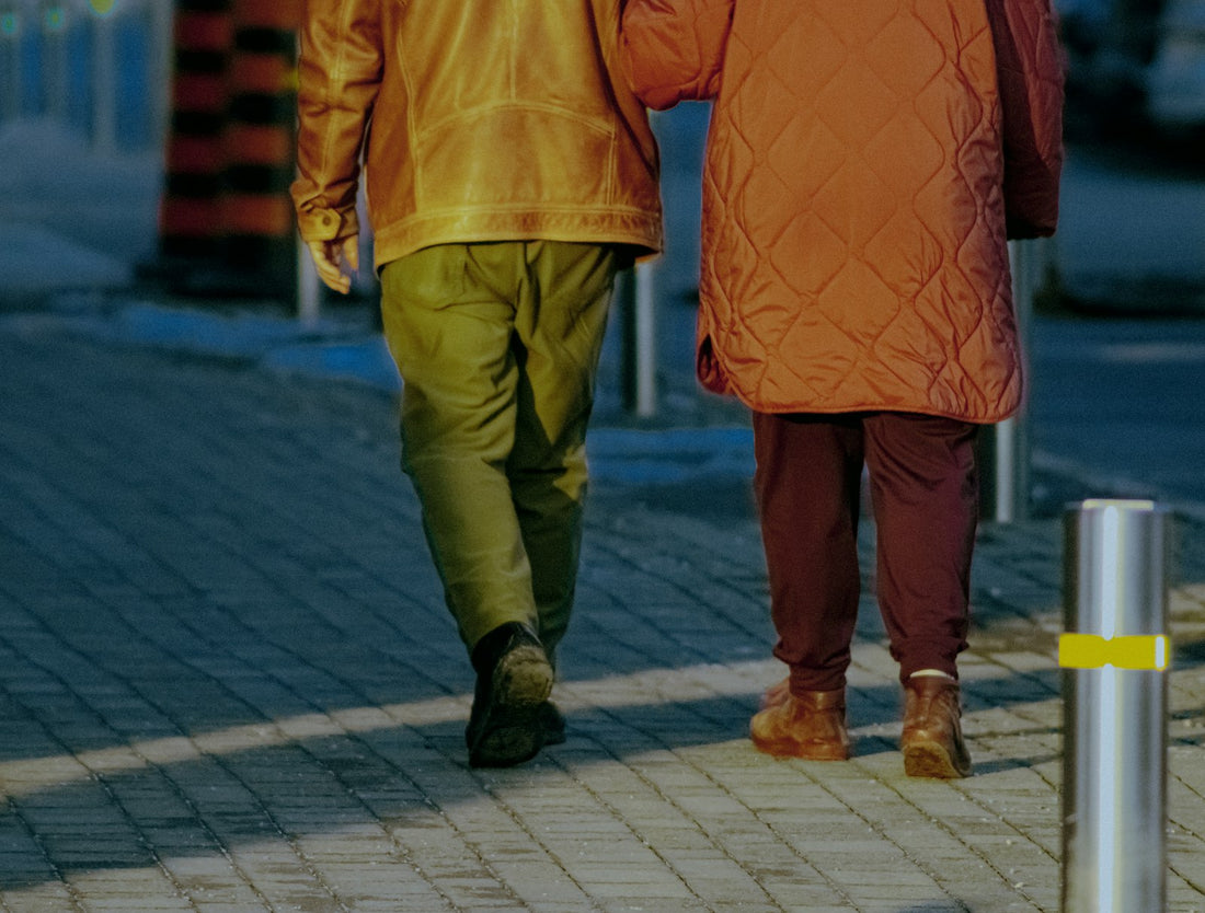 Two people walking briskly outdoors